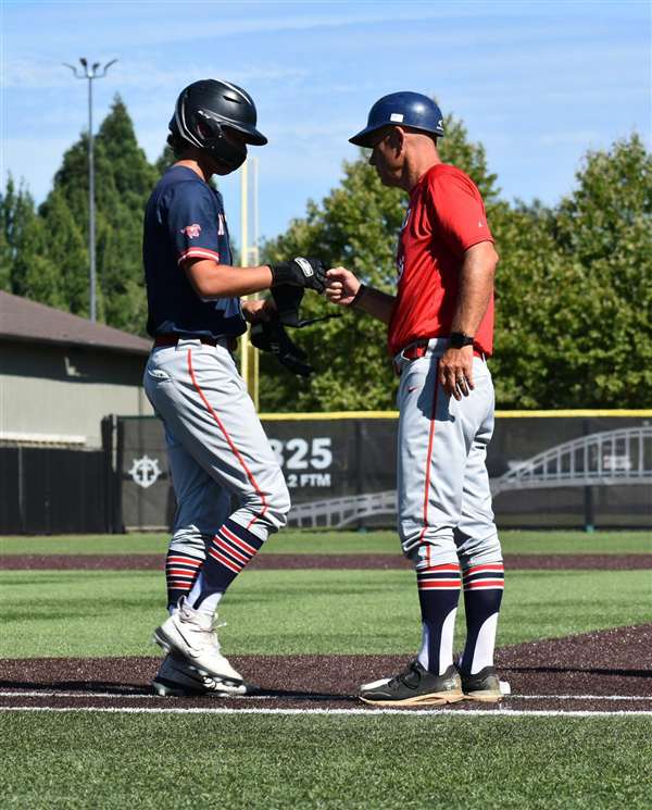 Medford Mustangs 2025 coach and player at third base