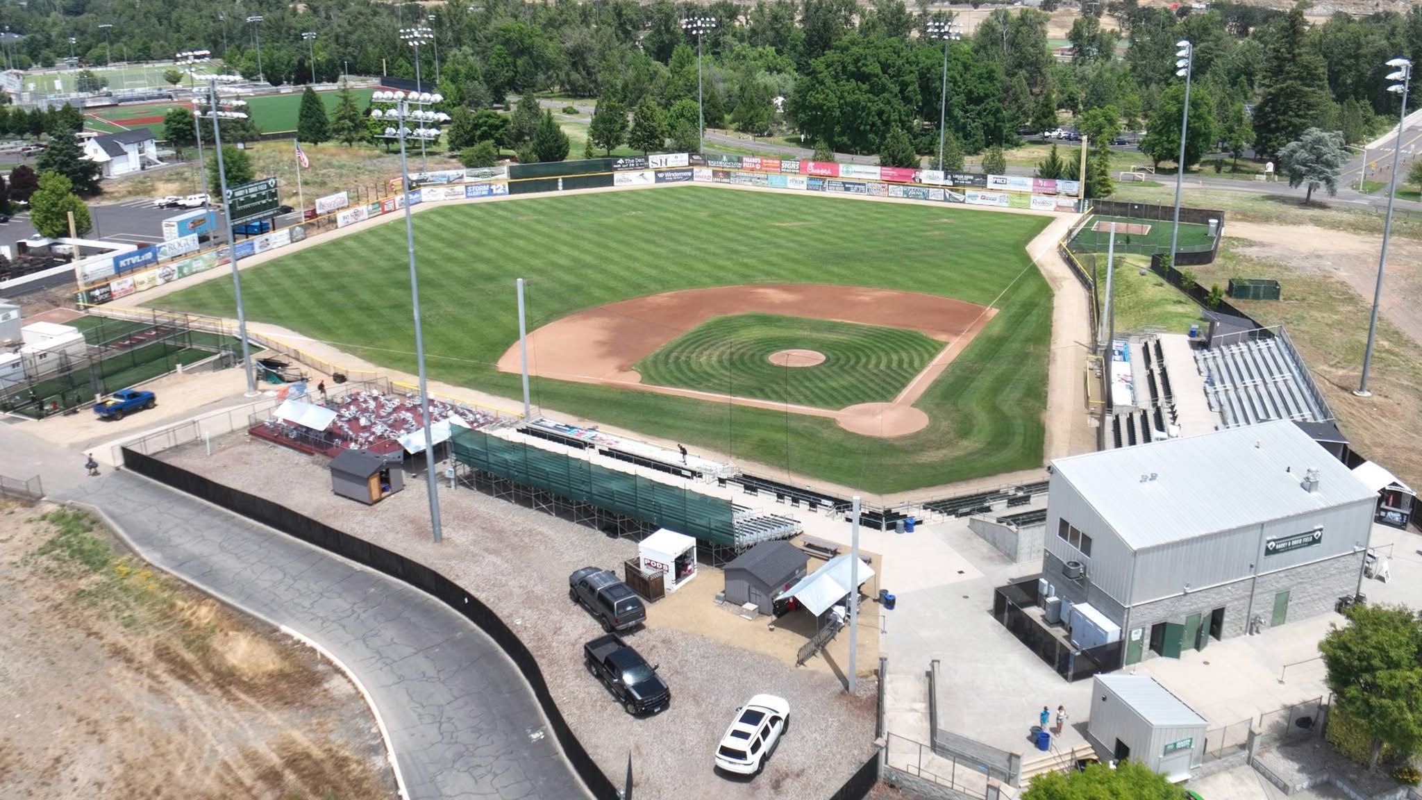 Aerial view down the third-base line at Harry & David Field with the Rogue Valley beyond, in Medford, Oregon.