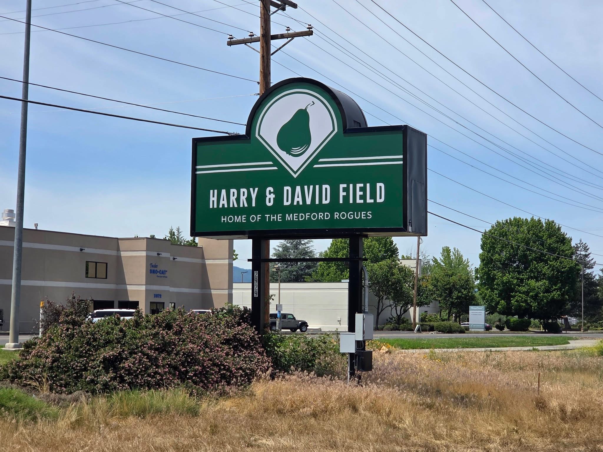 Harry & David Field entrance sign reading &lsquo;Home of the Medford Rogues&rsquo; along the street in Medford, Oregon.
