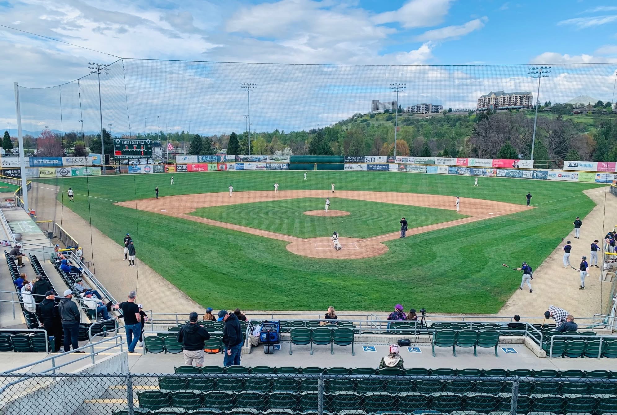 Harry & David Field in Medford, Oregon &mdash; home of the Medford Mustangs and host venue for the Oregon AAA American Legion State Tournament. View from behind home plate during a Mustangs game with the Rogue Valley hills in the background.